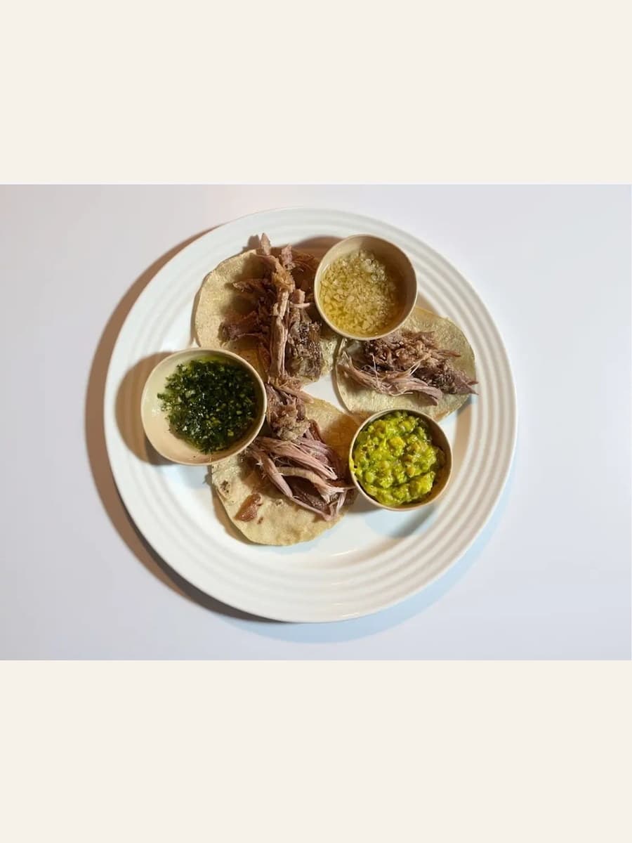 Soft roast pork tacos sold by Santa Perla