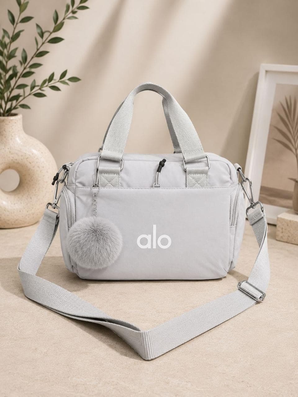 ALO Crossbody Handbag with Pom-Pom - Light Gray sold by Pamper Yourself